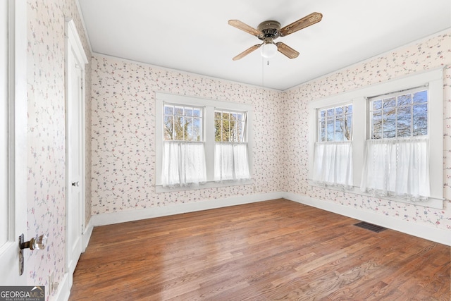 unfurnished room with ceiling fan and hardwood / wood-style flooring