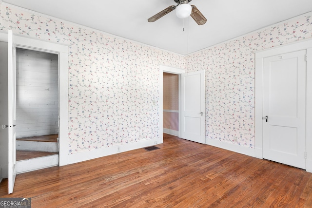 unfurnished bedroom with ceiling fan and hardwood / wood-style floors