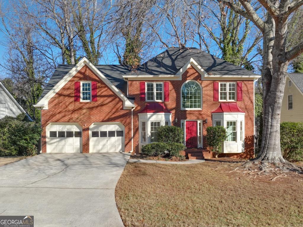 view of front of property with a front lawn and a garage