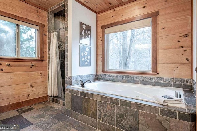 bathroom with wood walls, wooden ceiling, and shower with separate bathtub