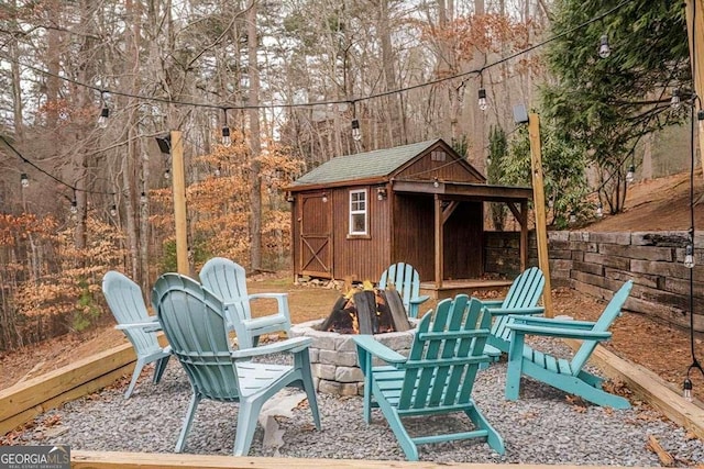 view of patio with a storage shed and an outdoor fire pit