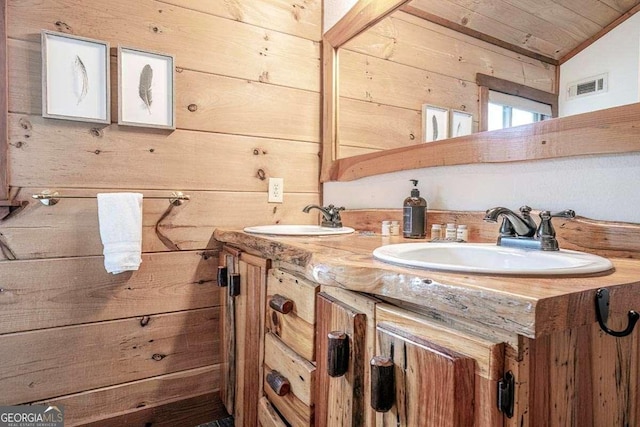 bathroom featuring vanity, wooden ceiling, wooden walls, and vaulted ceiling