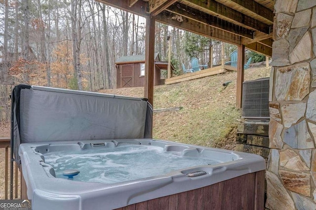 exterior space featuring a storage shed and a hot tub