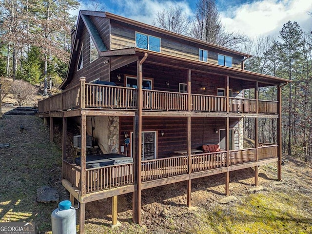 rear view of house with a wooden deck