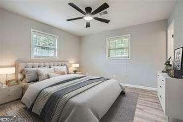 bedroom with wood-type flooring and ceiling fan