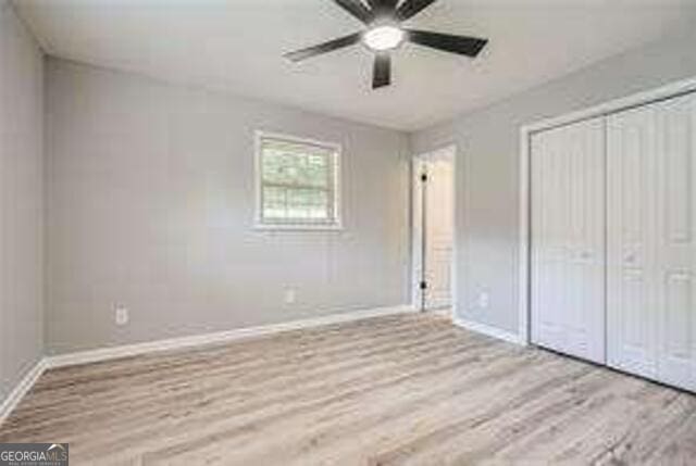 unfurnished bedroom with a closet, ceiling fan, and light hardwood / wood-style flooring