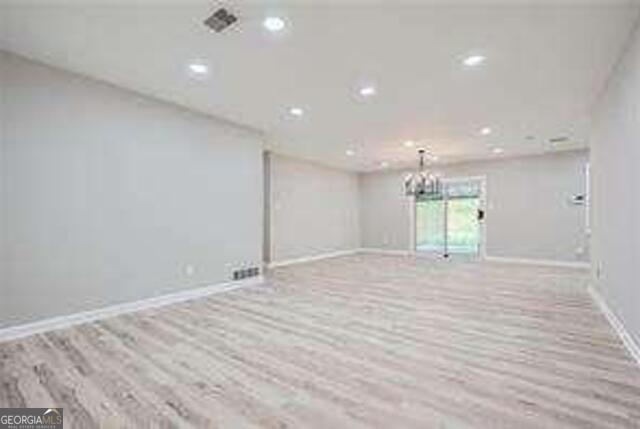 unfurnished room featuring light hardwood / wood-style flooring