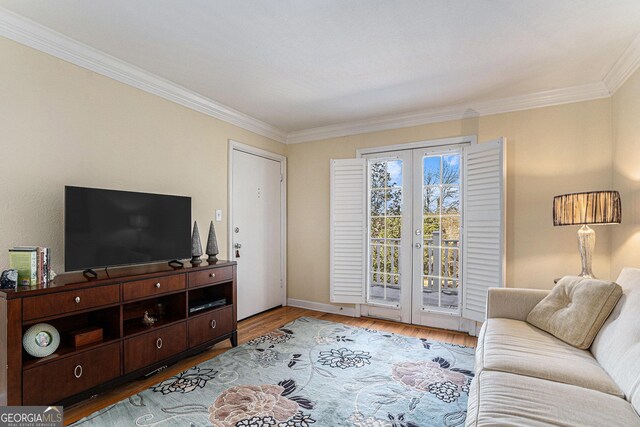 living room with wood-type flooring and ornamental molding