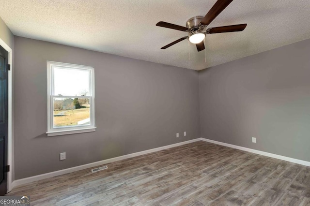 spare room featuring ceiling fan, a textured ceiling, and light hardwood / wood-style flooring