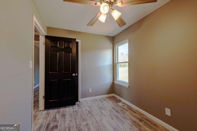 spare room with ceiling fan and light hardwood / wood-style flooring