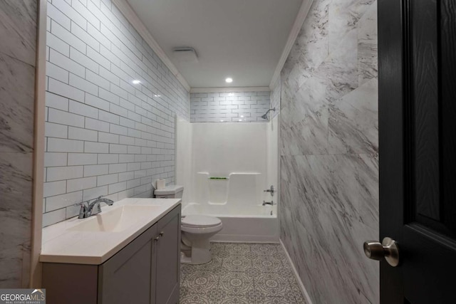 full bathroom featuring vanity, shower / washtub combination, toilet, ornamental molding, and tile walls