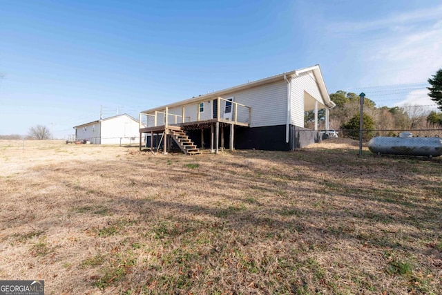 back of house with a deck