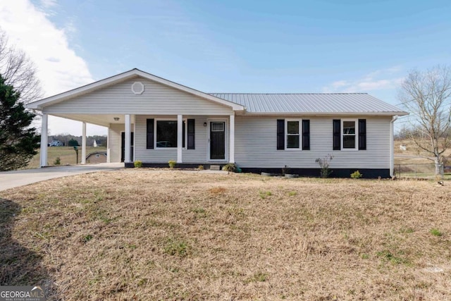 ranch-style house featuring a front yard and a carport