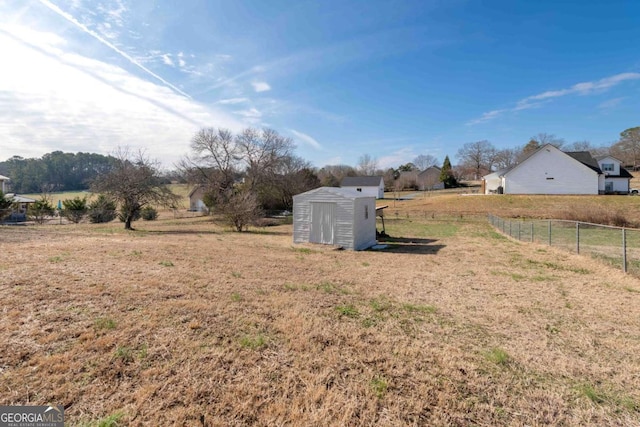 view of yard featuring a rural view and a shed