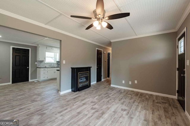 unfurnished living room featuring ceiling fan, light hardwood / wood-style flooring, and ornamental molding