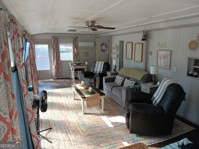 living room with an AC wall unit and ceiling fan