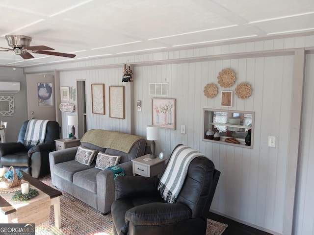 living room featuring wooden walls, ceiling fan, and a wall unit AC