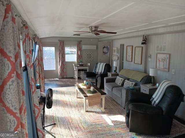 living room with ceiling fan and a wall unit AC