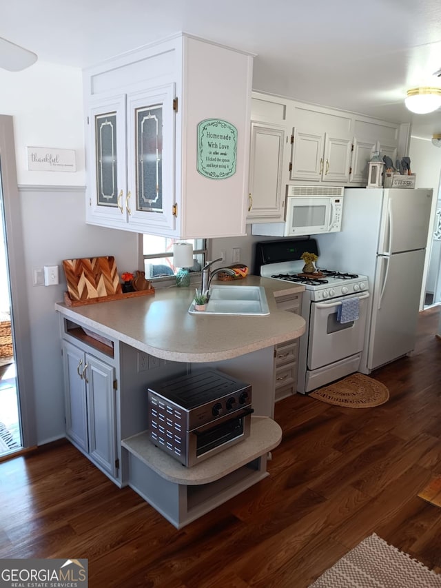 kitchen featuring white cabinets, white appliances, sink, and dark wood-type flooring