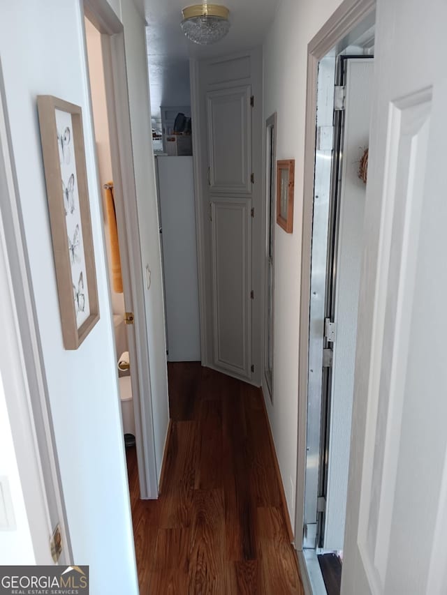 hallway featuring dark hardwood / wood-style floors