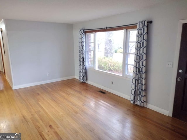 spare room with light wood-type flooring