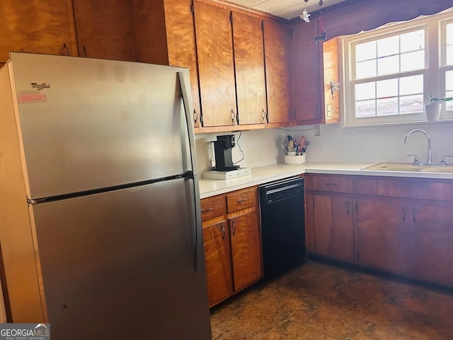 kitchen with stainless steel fridge, sink, and black dishwasher