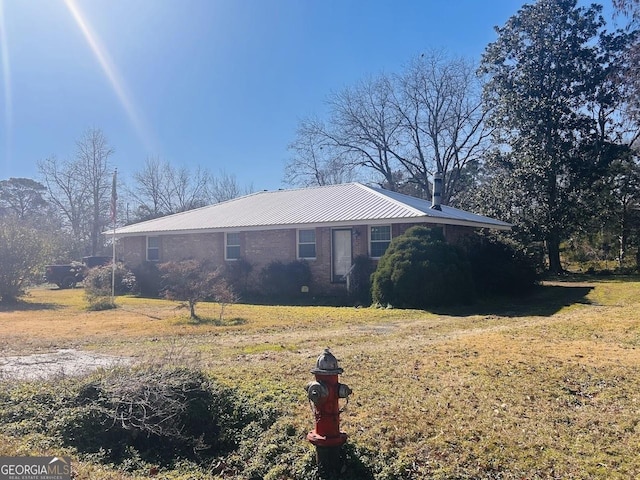 view of side of property with a yard