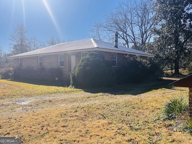 view of side of home featuring a yard