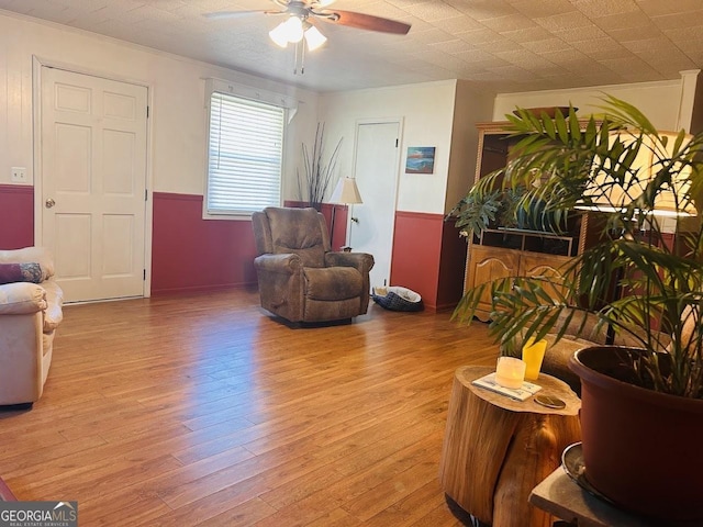 living room with light wood-type flooring and ceiling fan