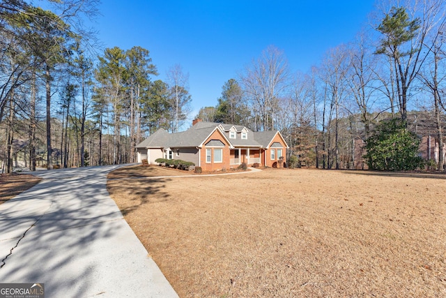 view of front of home with a garage and a front lawn