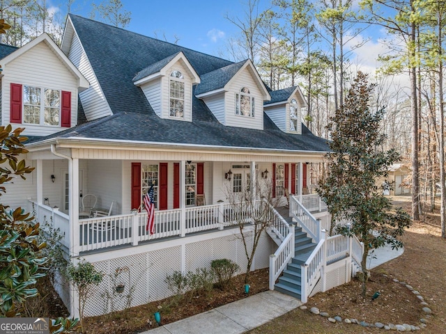 view of front of home featuring roof with shingles and a porch