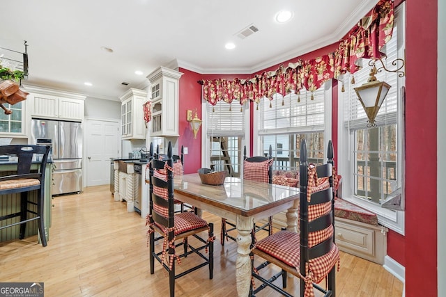 dining space featuring baseboards, recessed lighting, light wood finished floors, and ornamental molding