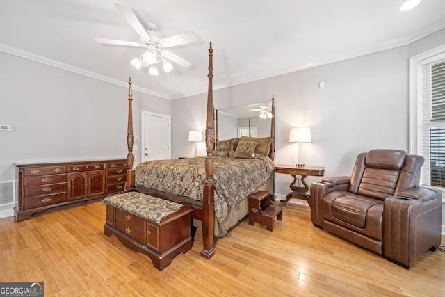 bedroom featuring visible vents, ceiling fan, light wood-style floors, and ornamental molding