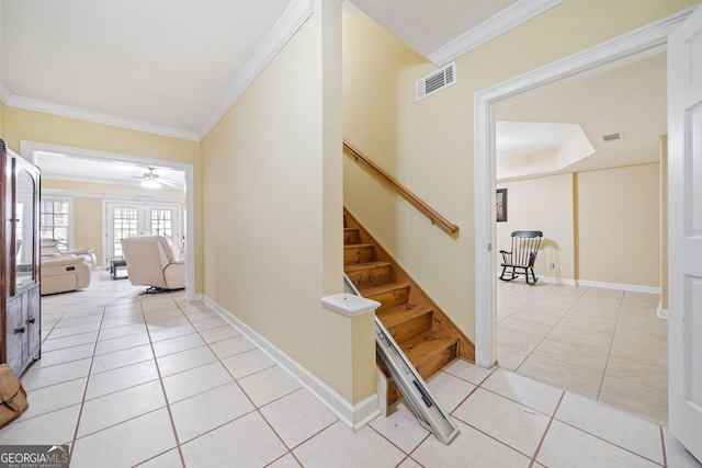 stairs featuring tile patterned flooring, visible vents, baseboards, and ornamental molding