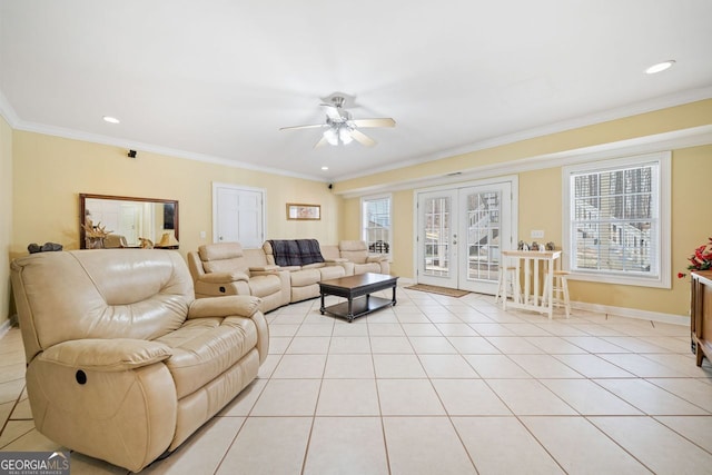 living area with plenty of natural light, french doors, light tile patterned floors, and ornamental molding