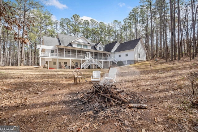 back of house with a sunroom and stairway