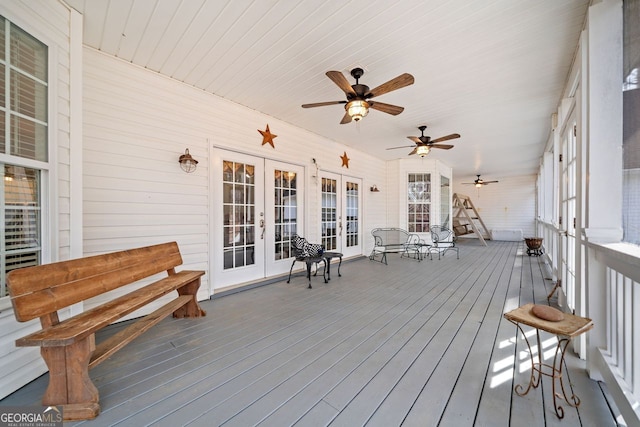 deck with french doors and a ceiling fan