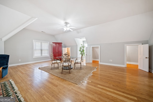 dining area featuring baseboards, vaulted ceiling, light wood finished floors, and ceiling fan