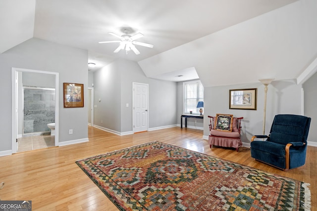 sitting room featuring lofted ceiling, baseboards, a ceiling fan, and wood finished floors