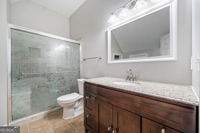 bathroom with a stall shower, vanity, toilet, and tile patterned floors