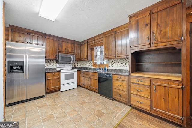 kitchen featuring dark countertops, appliances with stainless steel finishes, open shelves, and backsplash