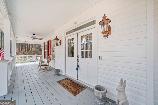 wooden deck with covered porch and a ceiling fan