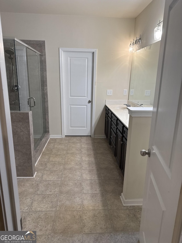 bathroom featuring vanity and an enclosed shower