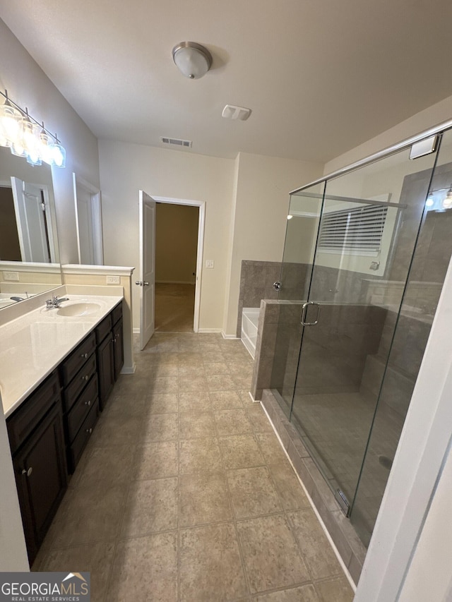 bathroom with shower with separate bathtub and vanity