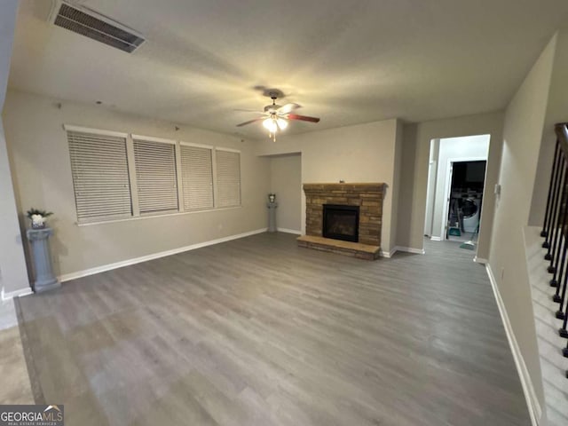 unfurnished living room featuring wood-type flooring, a fireplace, and ceiling fan