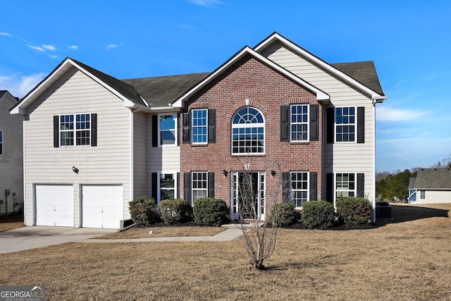 view of front of property with a front yard, a garage, and central AC unit