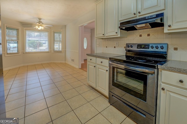 kitchen with electric stove, ceiling fan, light tile patterned floors, and decorative backsplash