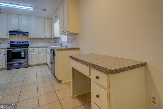 kitchen with stainless steel electric range oven, sink, light tile patterned floors, black dishwasher, and white cabinetry