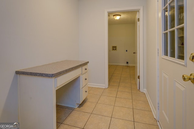 interior space with white cabinetry and light tile patterned flooring