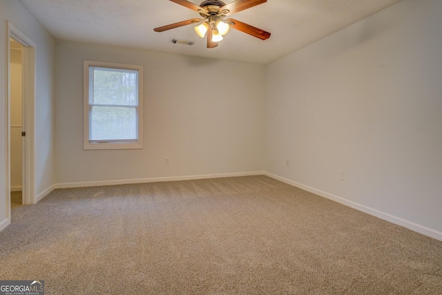 spare room with carpet and ceiling fan